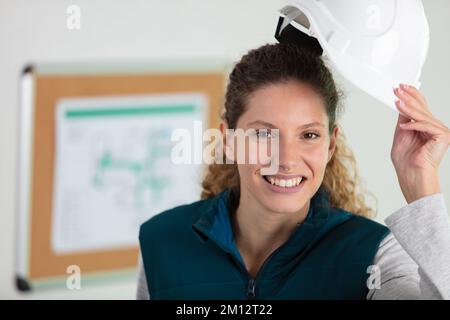 female contractor engineer with hat at construction site Stock Photo