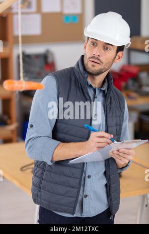 motivation concept - builder looking at hanging carrot Stock Photo