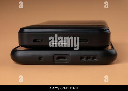 portable power bank accumulator and phone black color. Stock Photo