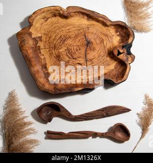 handmade carved wooden kitchen tools on the table Stock Photo