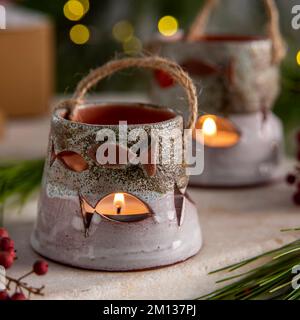 ceramic candle holders with gift boxes and christmas decoration Stock Photo