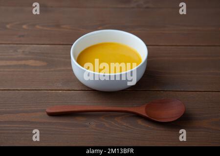 pumpkin potage soup isolated on table Stock Photo
