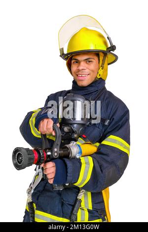 Fireman in uniform and hardhat holds firehose in hands Stock Photo