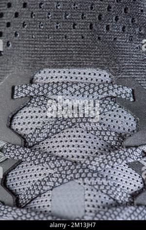 Sneakers close-up. Shoelaces of new sports shoes in gray, lacing sneakers close-up, top view. Mesh elastic laces for fitness. Sport and active Stock Photo