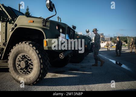 U.S. Marine Corps motor vehicle operators with Motor Transportation Company, Combat Logistics Battalion 4, Combat Logistics Regiment 3, 3rd Marine Logistics Group, embark Joint Light Tactical Vehicles to transport them onto U.S. Army Landing Craft Utility Calaboza, during exercise Winter Workhorse 23 at Naha Military Port, Okinawa, Japan, Dec. 4, 2022. Winter Workhorse is an annual exercise for CLR-3 to train to carry out mission-essential tasks in forward-deployed, austere environments. (U.S. Marine Corps photo by Cpl. Madison Santamaria) Stock Photo