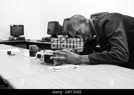 A man working on a technological instrument at Vocational Skills Training Centre in Johannesburg, South Africa Stock Photo