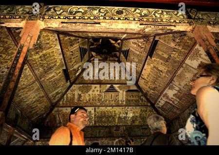 Tourists at Kertha Gosa, an iconic pavilion that its ceiling showcasing old, traditional Balinese Kamasan painting style, located in Klungkung, Bali. Stock Photo