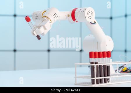 Robotic arm holding blood sample Stock Photo