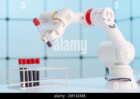 Robotic arm holding blood sample Stock Photo