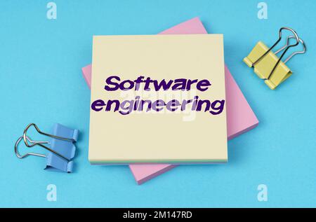 Business and finance concept. On the table are paper clips, note paper with text - Software engineering Stock Photo