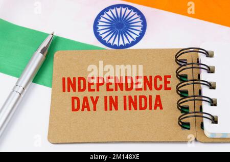 Holidays in India. Against the background of the flag of India lies cardboard with the inscription - Independence Day in India Stock Photo