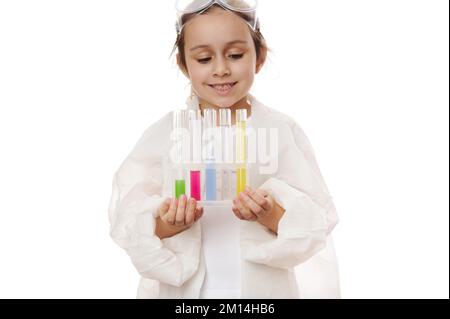 Laboratory test tubes with colorful reagents and chemicals on tripod in child's hands, isolated on white background Stock Photo