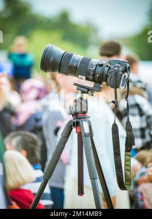 DSLR or mirrorless camera on a tripod with a telephoto lens Stock Photo