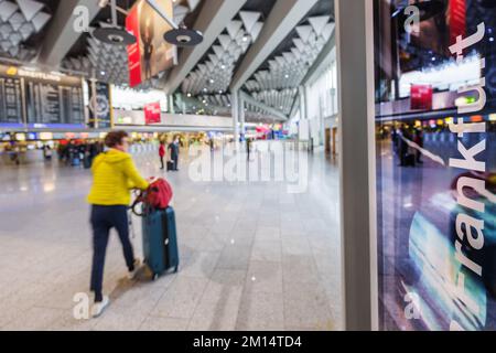 08 December 2022, Hessen, Frankfurt/Main: A woman walks through Terminal 1. Photo: Andreas Arnold/dpa Stock Photo