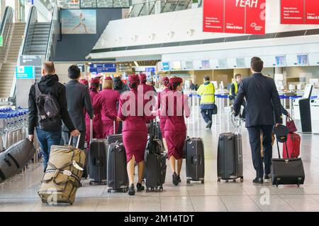 08 December 2022, Hessen, Frankfurt/Main: Flying personnel of the airline Qatar Airways walk through Terminal 1. Photo: Andreas Arnold/dpa Stock Photo