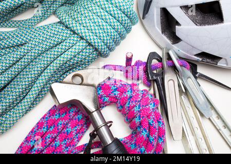 Traditional climbing gear with rope, hooks, hammer and helmet on white background Stock Photo