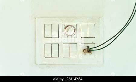 Dust shield with sockets and switches on the street on a white wall, electric Stock Photo