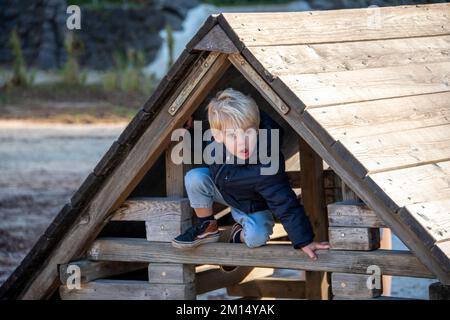 Near view of a young child at the playground on a sunny day Stock Photo