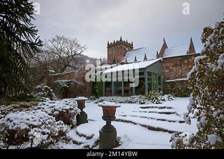 Duddingston, Dr Neil's Garden, Edinburgh, Scotland, UK 10th December 2022. The virgin snow highlights Duddingston Kirk behind for this wintry scene. In 1963 Dr's Andrew and Nancy Neil local GPs (who both died in 2005) began work on part of the Duddingston Glebe (church land) and Dr Neil's Garden was born. The ground had previously been grazed by calves and geese but its steep slope and rocks made it unsuitable for crops, so never previously cultivated before the Neil's transformed the site into a series of beautiful terraces.  Temperature 0 degrees centigrade. Credit: Archwhite/alamy live news Stock Photo