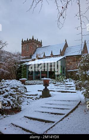Duddingston, Dr Neil's Garden, Edinburgh, Scotland, UK 10th December 2022. The virgin snow highlights Duddingston Kirk behind for this wintry scene. In 1963 Dr's Andrew and Nancy Neil local GPs (who both died in 2005) began work on part of the Duddingston Glebe (church land) and Dr Neil's Garden was born. The ground had previously been grazed by calves and geese but its steep slope and rocks made it unsuitable for crops, so never previously cultivated before the Neil's transformed the site into a series of beautiful terraces.  Temperature 0 degrees centigrade. Credit: Archwhite/alamy live news Stock Photo