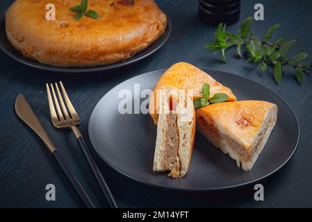 Chicken pie in a plate on a wooden table