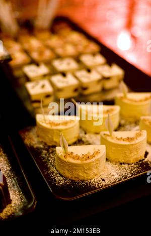 The buffet at the reception. Assortment of canapes on wooden board. Banquet service. catering food, snacks/////// Stock Photo