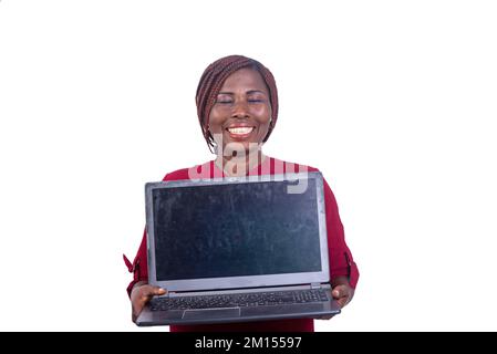 portrait of a beautiful adult woman with closed eyes showing a laptop while smiling. Stock Photo