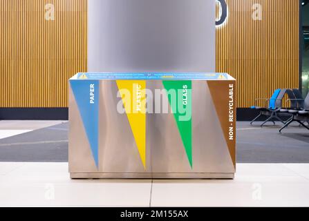 Recycle bin indoors. Metallic recycling bin standing in waiting room. Garbage container. Stock Photo