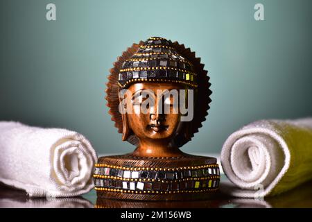 handcrafted buddha figurine on table Stock Photo