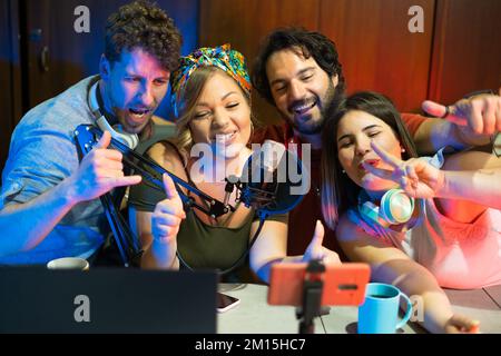 Group of influencer connecting live streaming on social media platforms - A new technologic generation having fun while recording videos online Stock Photo