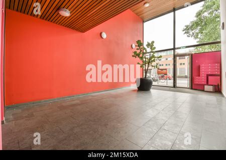 In perspective illuminated empty hall of a building with entrance next a bright window Stock Photo