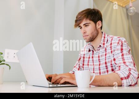 Young Man Working at the Office with a laptop Stock Photo