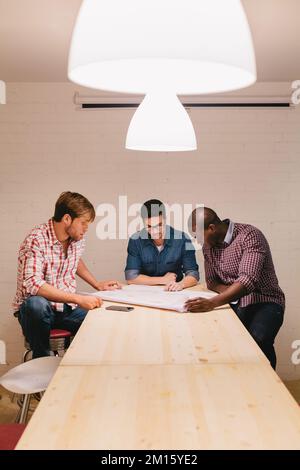 Architects and engineers working at the Office sitting in a large table Stock Photo