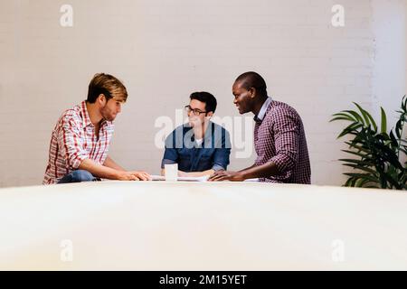 Three Architects and engineers working at the Office Stock Photo