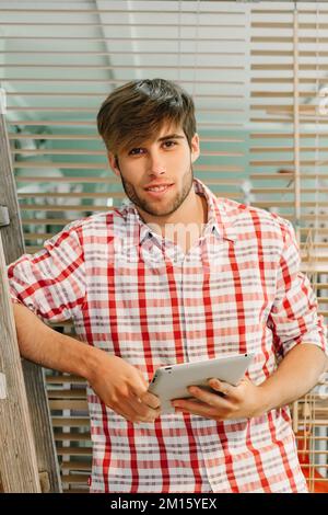 Young Entrepreneur at the Office Holding a Digital Tablet Stock Photo
