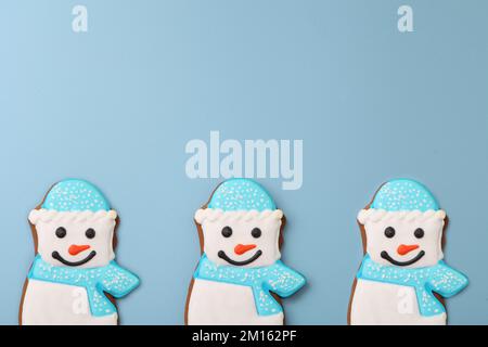snowman gingerbread on blue background. Christmas cookie pattern. Blue seamless Winter holidays Stock Photo