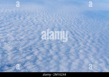 Background of a pink white heavenly sky with fluffy dense clouds, top view from an airplane. Sky Gradient. Can be used as advertising background, over Stock Photo