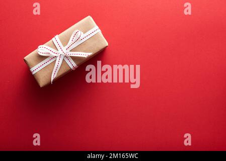 Small christmas gift wrapped in craft paper Stock Photo