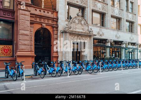 New York, USA - November 21, 2022: Row of Citi Bikes parked at the docks on a street in New York. Citi Bike is a privately owned public bicycle sharin Stock Photo