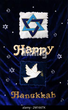 Blue Velvet Happy Hanukkah Banner showing Star of David and Dove of Peace Stock Photo