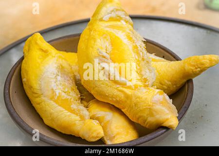 Durian is famous tropical fruit. It is native in South East Asian countries. It has distinct or strong smells that some people may feel disgusting, smelly Stock Photo