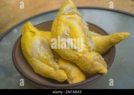 Durian is famous tropical fruit. It is native in South East Asian countries. It has distinct or strong smells that some people may feel disgusting, smelly Stock Photo