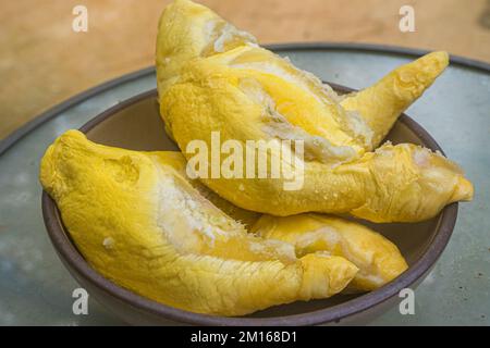 Durian is famous tropical fruit. It is native in South East Asian countries. It has distinct or strong smells that some people may feel disgusting, smelly Stock Photo