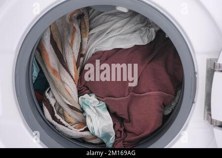 A fully loaded washing machine. Close up. Stock Photo