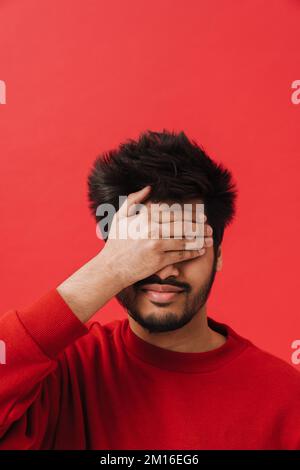 Young Indian man covering his eyes with his hands Stock Photo - Alamy