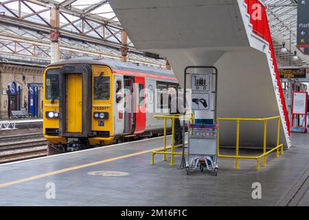 Crewe Railway station, Cheshire, UK Transport for Wales class 153 sprinter train  with train drivers chatting during the station stop. Stock Photo