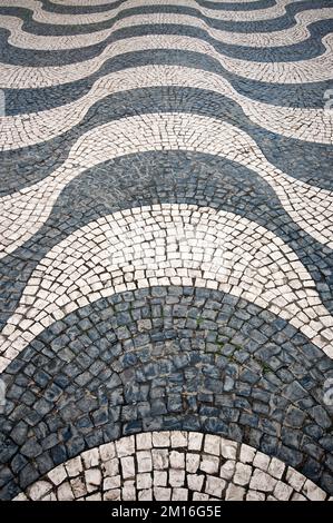 Wave pattern of cobblestone pavement in Praca Dom Pedro IV (Rossio square), Lisbon, Portugal Stock Photo