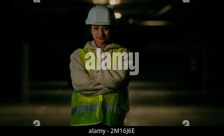 Professional engineer female architect inspector builder arabian woman in uniform protective helmet posing on parking female worker technician Stock Photo