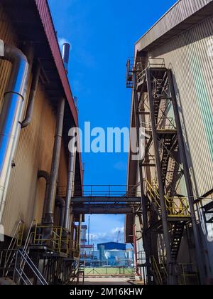 A low angle shot of a kernel processing plant and kernel dust warehouse ...