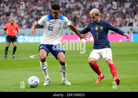 England's Jude Bellingham battles for possession of the ball with France's Antoine Griezmann during the FIFA World Cup Quarter-Final match at the Al Bayt Stadium in Al Khor, Qatar. Picture date: Saturday December 10, 2022. Stock Photo